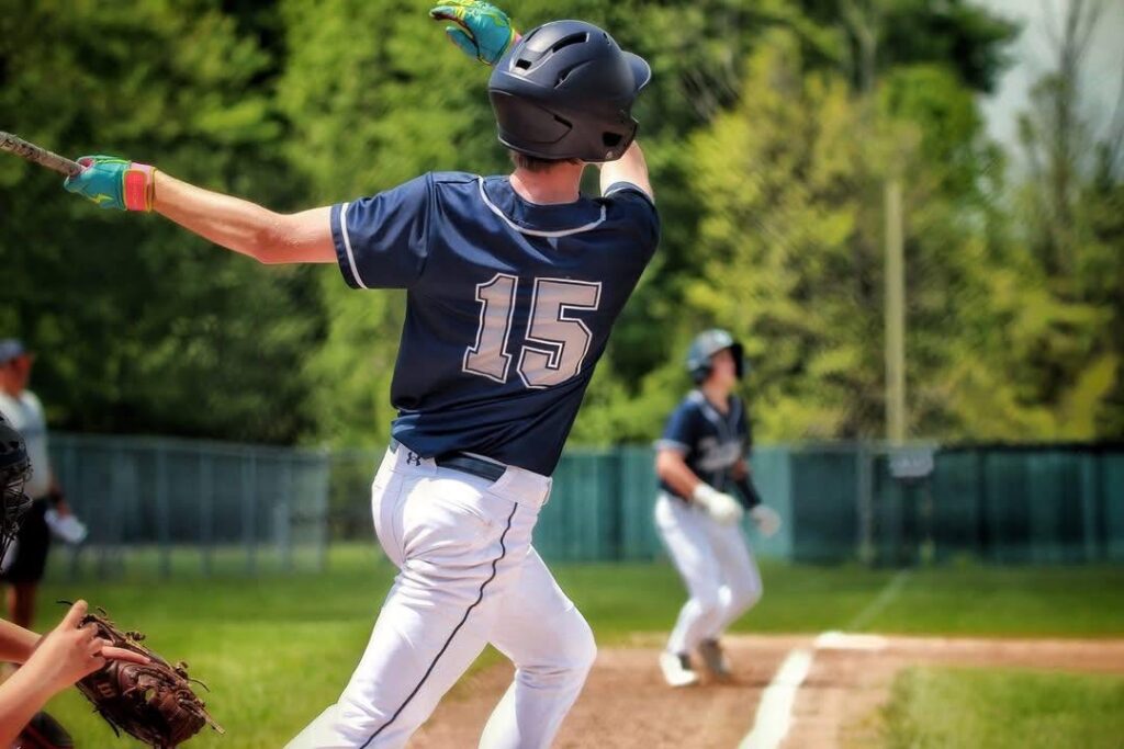 Baseball player with follow through after swing